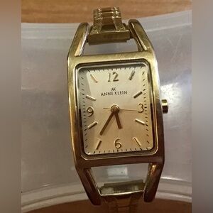 Anne Klein: woman’s gold toned stretchable wrist watch quartz Japan movement.
